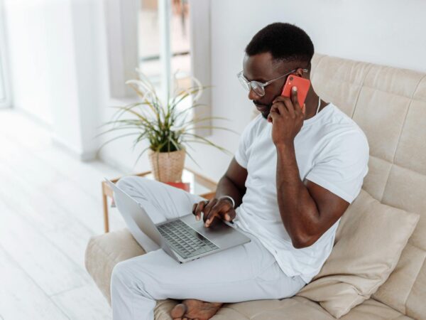 Man in White Crew Neck T-shirt Using Silver Laptop Computer